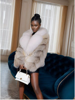 Detail close-up of plush white fox fur collar and soft fawn light fox material