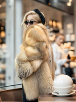 Front view of luxury golden island fox fur coat with plush thick texture and natural color